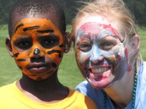CHE student posing with African American boy with faces painted