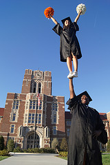 Graduates perform handstand in front of Ayres Hall.
