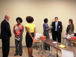 Networking mingle: students speak with potential employers during a career workshop