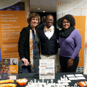 Dr. Kathy Brown poses with two Afican American students at the department information booth